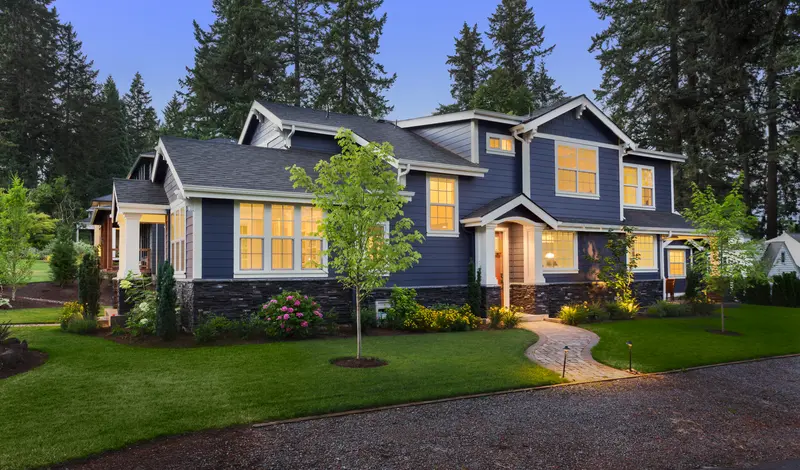 Professional exterior house painting service on blue home
