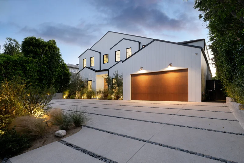 Modern stucco home exterior painted white with bold black trim.
