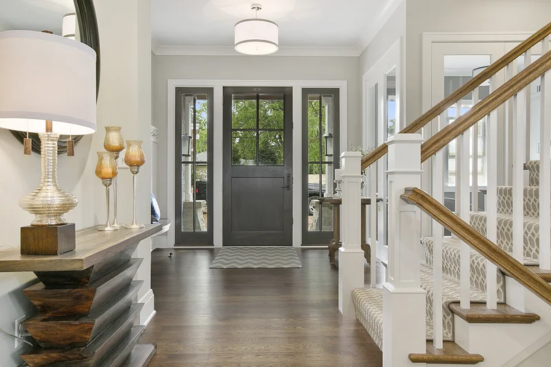 Modern home entryway foyer with staircase and wooden flooring