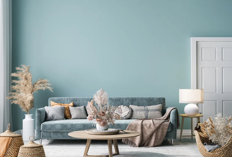 Dusty blue painted living room accent wall with modern sofa