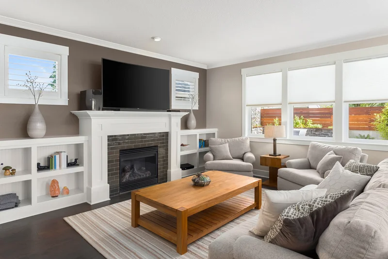 Modern living room featuring a warm brown accent wall and fireplace